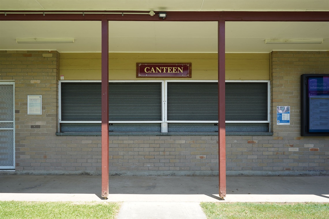 Front view of The Kiosk with servery windows, ‘Canteen’ sign and Community Information Hub screen.