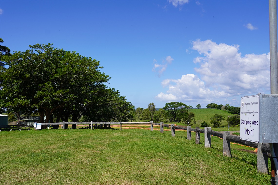 The sign and fencing near the campground, showing the views of the hills and sky.