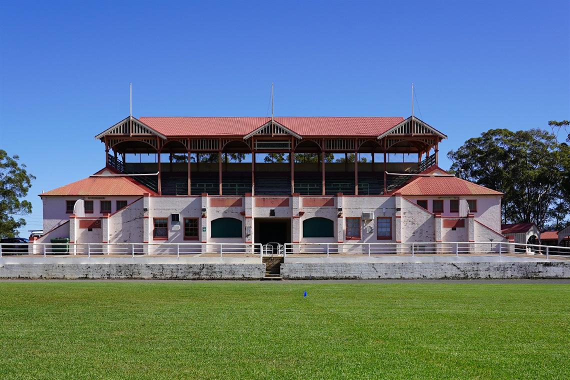 Complete front view of Nowra Showground Pavilion Exhibition Hall building with the main arena in the foreground.