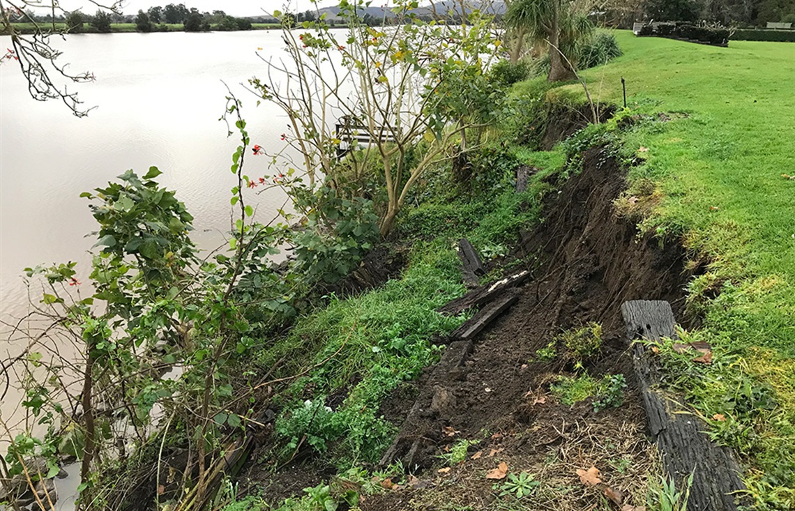 A photo of a flood levee with significant erosion caused by severe flooding.