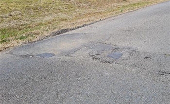 Older patched potholes on Bryces Road