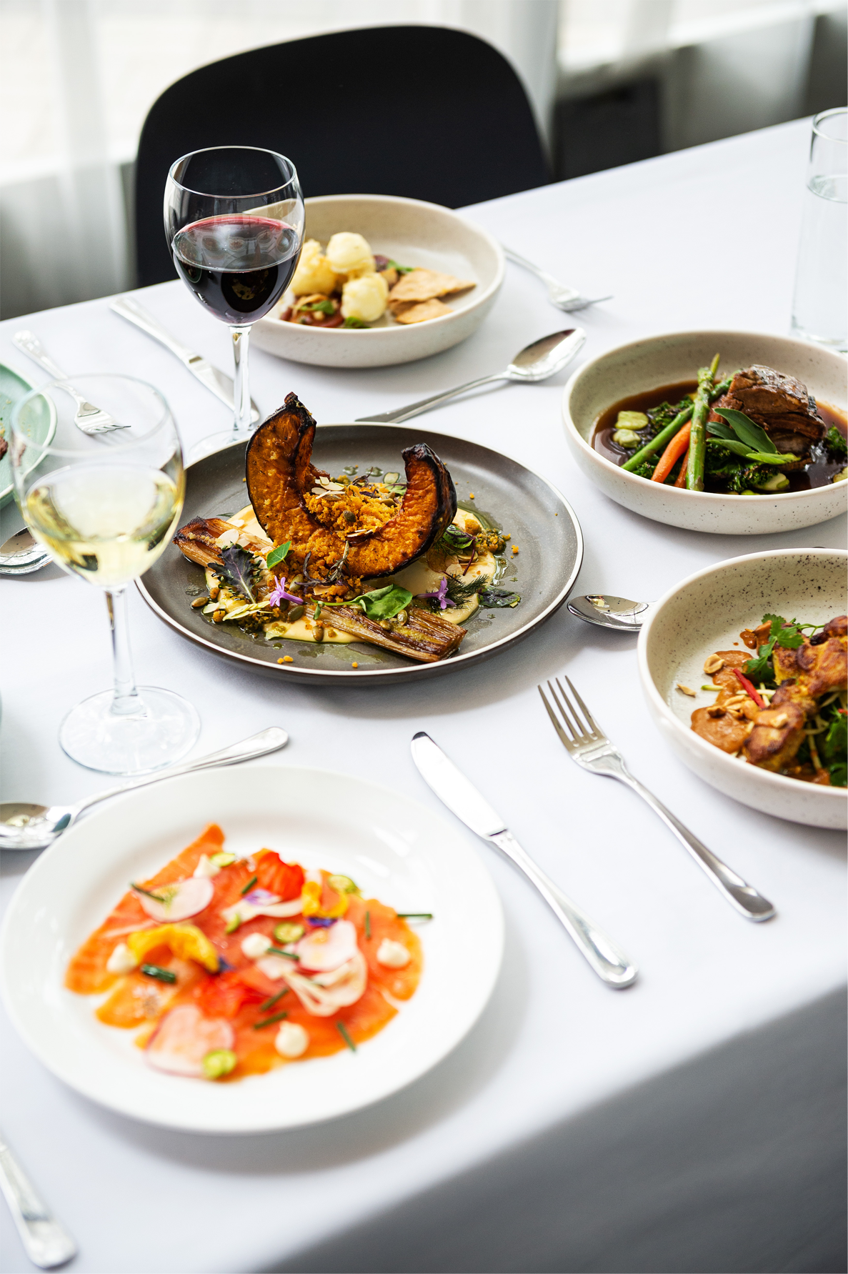 A range of Encore Dining meals, including roast pumpkin, chicken skewers and braised lamb
