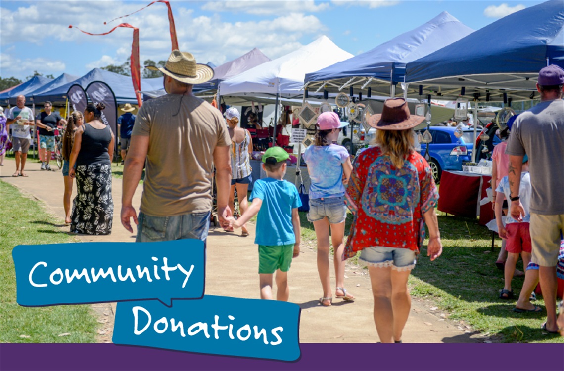 A photo of a family at a community market. They are walking towards the stalls. Text overlaid over the image reads 'Community Donations'.
