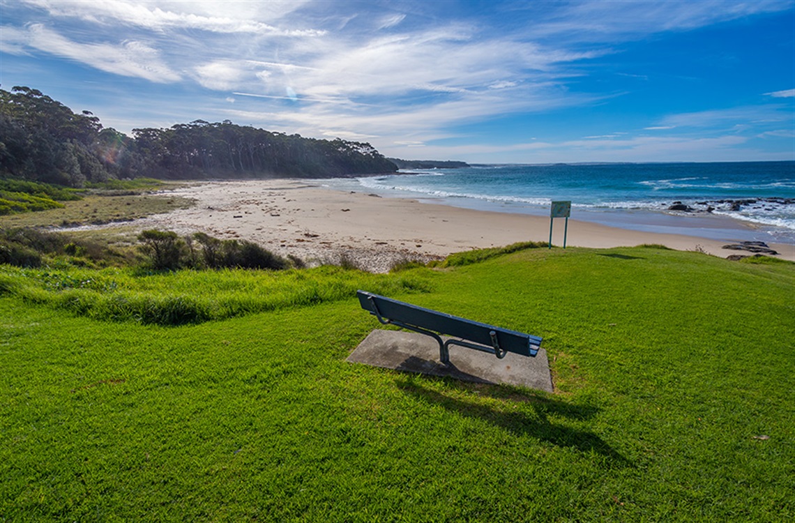 Bench seat in park overlooking the beach