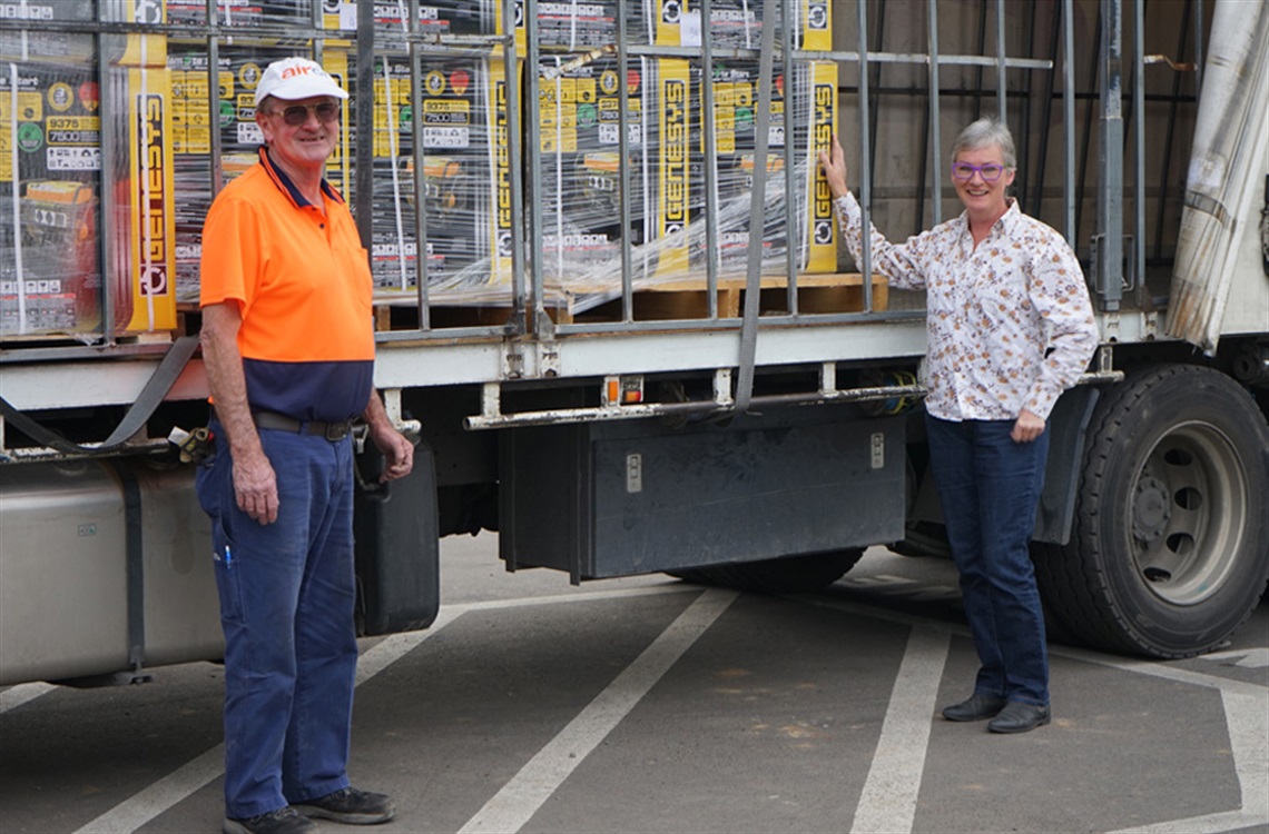 Mayor and truck driver posing in front of delivery